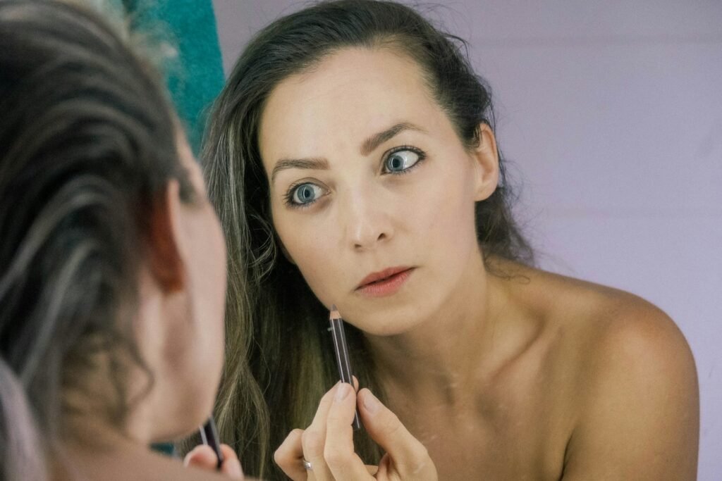a woman is looking at her reflection in the mirror